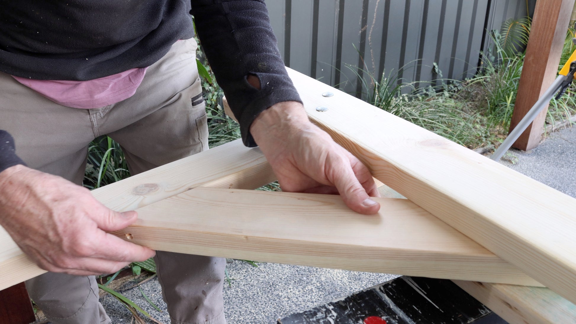 Image showing a cross brace being installed on a wedding arbor